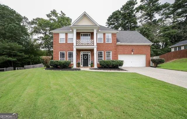 a front view of house with yard and green space