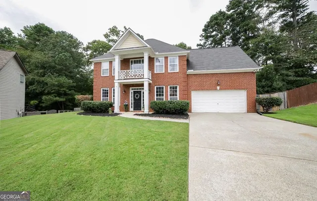 a front view of a house with a yard