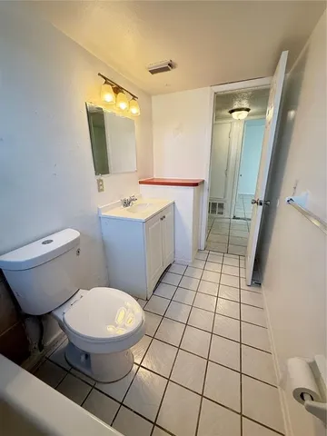a bathroom with a toilet a sink and a mirror