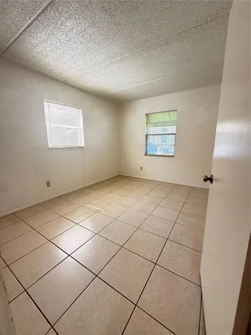 a view of an empty room and a window