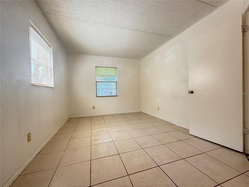 731 Michigan Court, Unit 1 St. Cloud, FL 34769 - Photo 14 of 18 a view of an empty room with a window