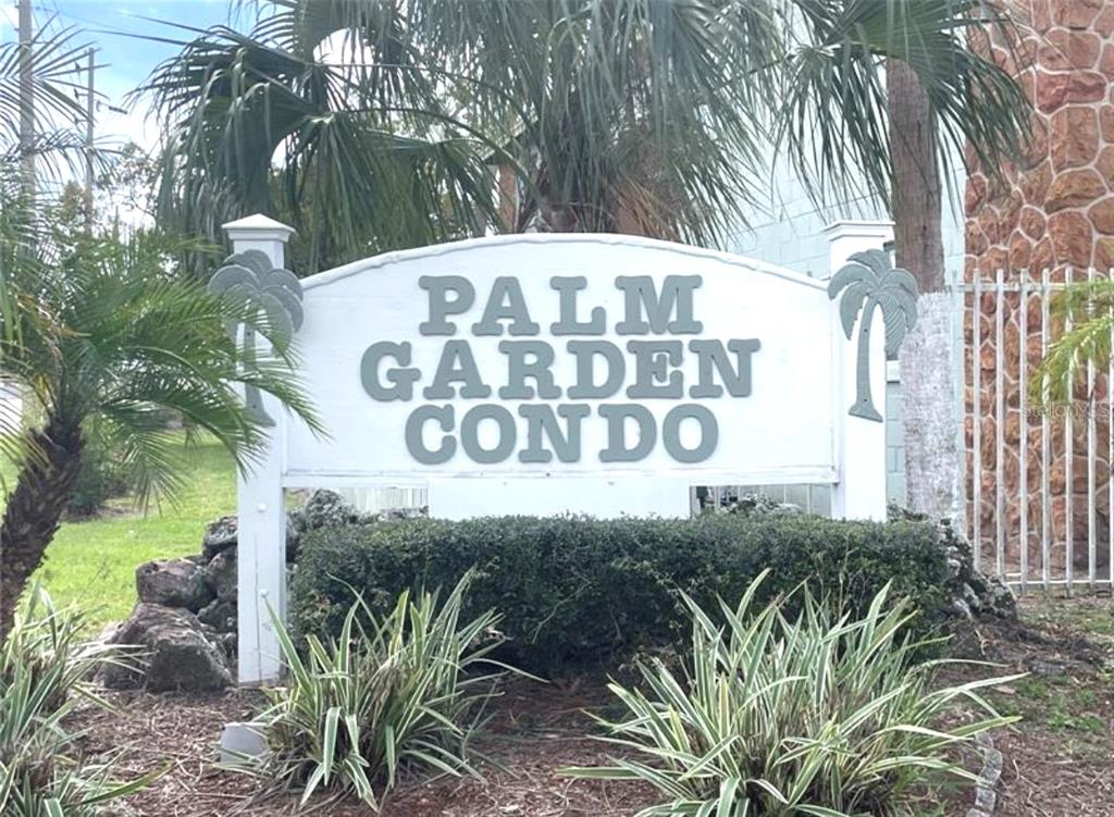731 Michigan Court, Unit 1 St. Cloud, FL 34769 - Photo 2 of 18 a view of a sign under a tree