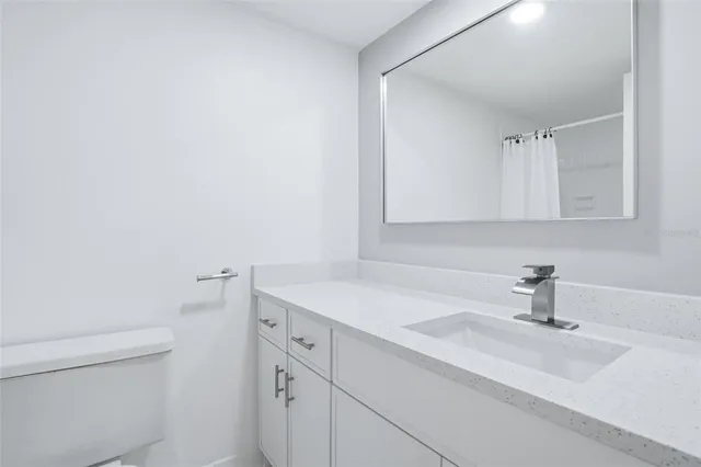 a view of an empty room with a window and a ceiling fan