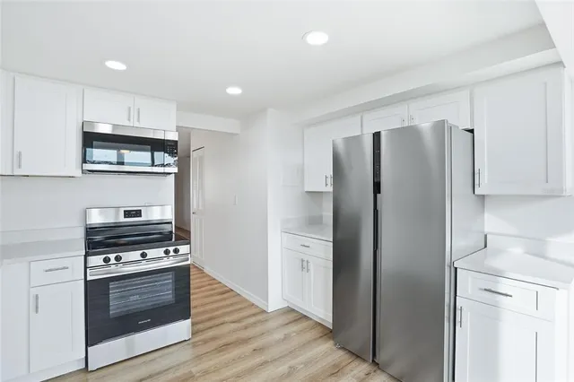 a kitchen with stainless steel appliances a refrigerator sink and stove top oven