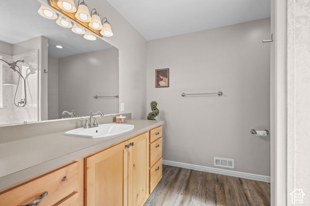 1045 West 3600th South Perry, UT 84302 - Photo 23 of 57 Extended vanity with light wood-finish cabinetry, integrated rectangular sink, and chrome-finish fixtures