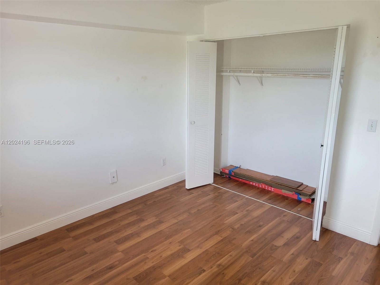 8260 Southwest 210th Street, Unit 319 Cutler Bay, FL 33189 - Photo 10 of 20 a view of room with wooden floor