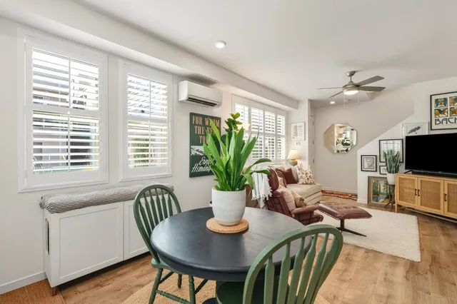 a view of a dining room with furniture window and wooden floor