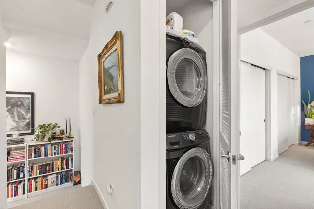 a view of a bedroom with washer and dryer