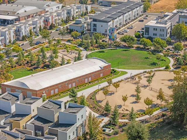 an aerial view of residential houses with outdoor space