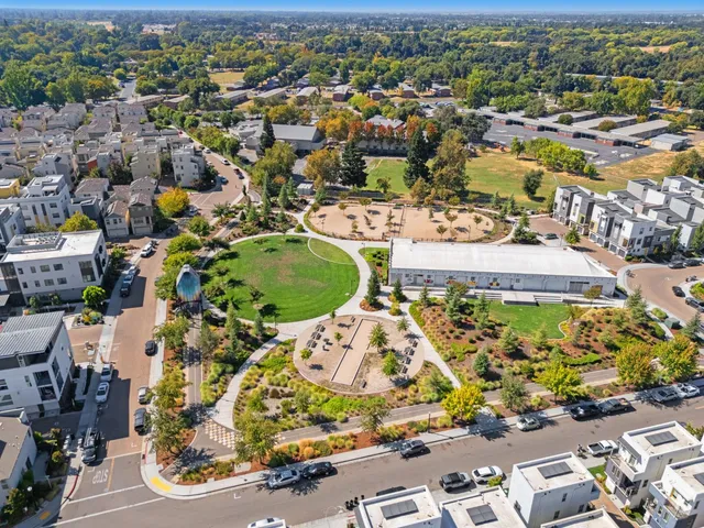 an aerial view of residential houses with outdoor space