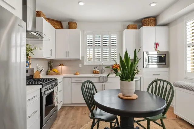 a view of a kitchen with furniture and a potted plant