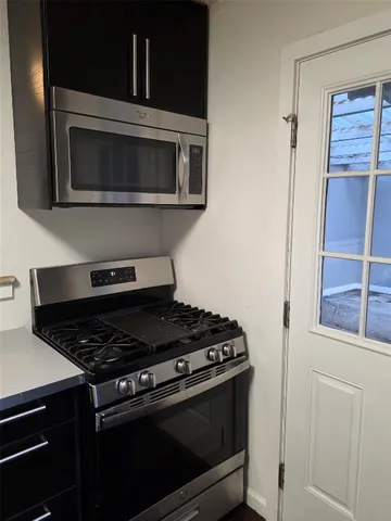 a stove top oven sitting inside of a kitchen