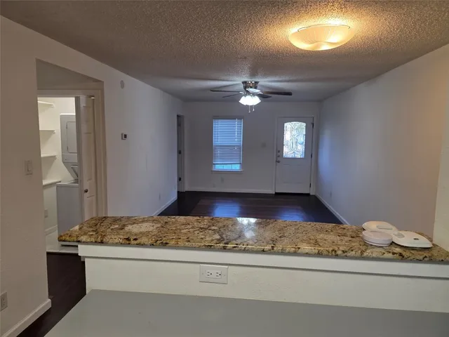 a view of kitchen with kitchen island stainless steel appliances counter space