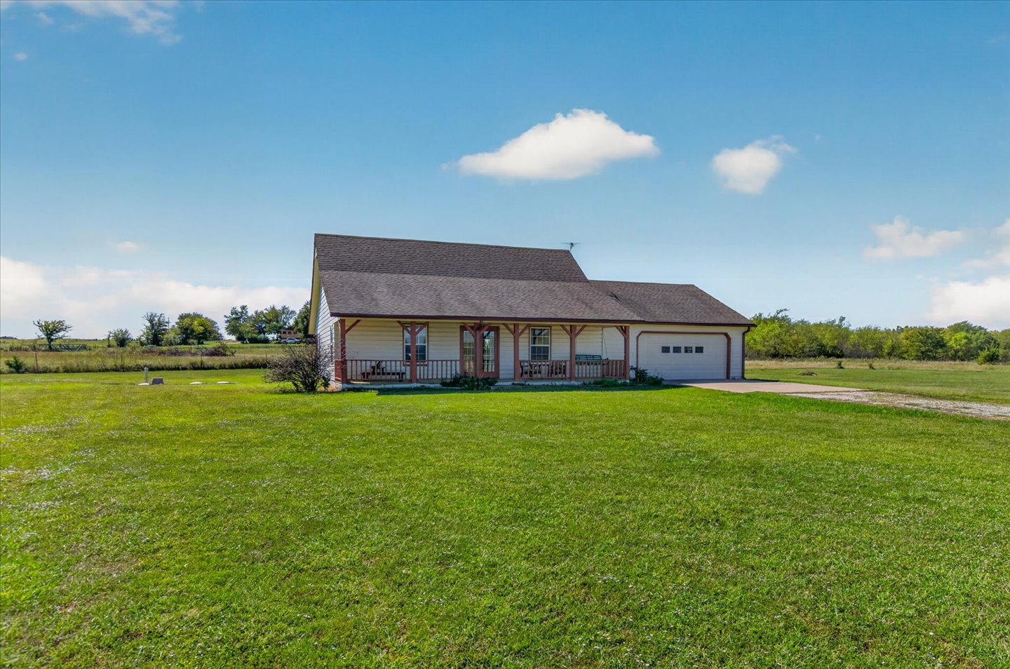 26115 4157th Road Nowata, OK 74048 - Photo 2 of 36 Charming rural residence featuring a pitched roof with dimensional shingles, front porch with covered entry, and attached two-car garage