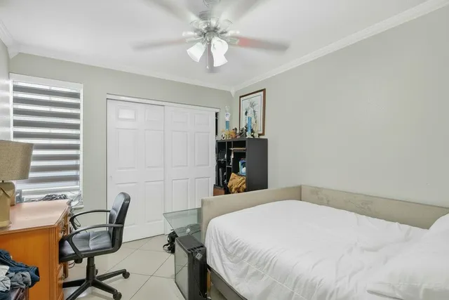 a bedroom with a bed a table and chair