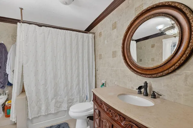 a bathroom with a sink a toilet and a mirror