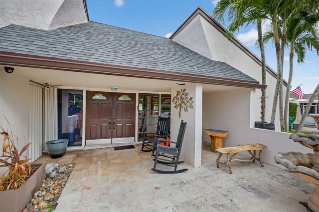 a view of a house with backyard and sitting area