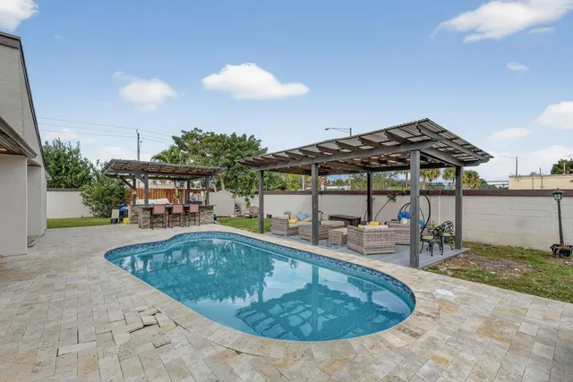 swimming pool view with a seating space