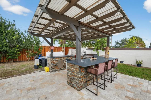 a roof deck with table and chairs