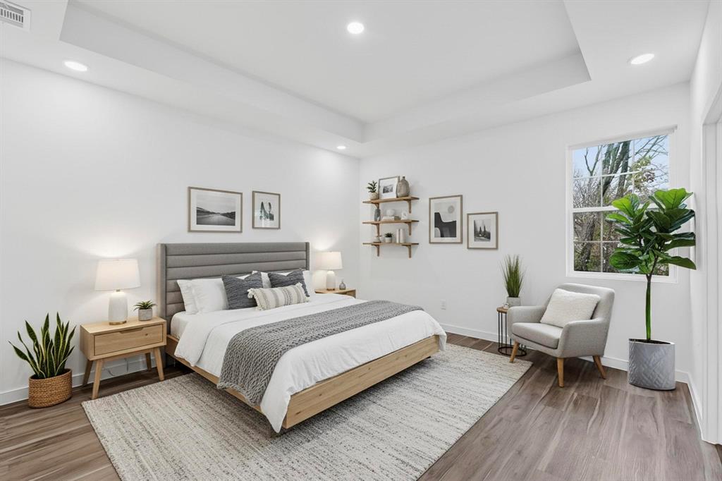 4606 Metropolitan Avenue Dallas, TX 75210 - Photo 11 of 21 a bedroom with a bed and a potted plant on dresser
