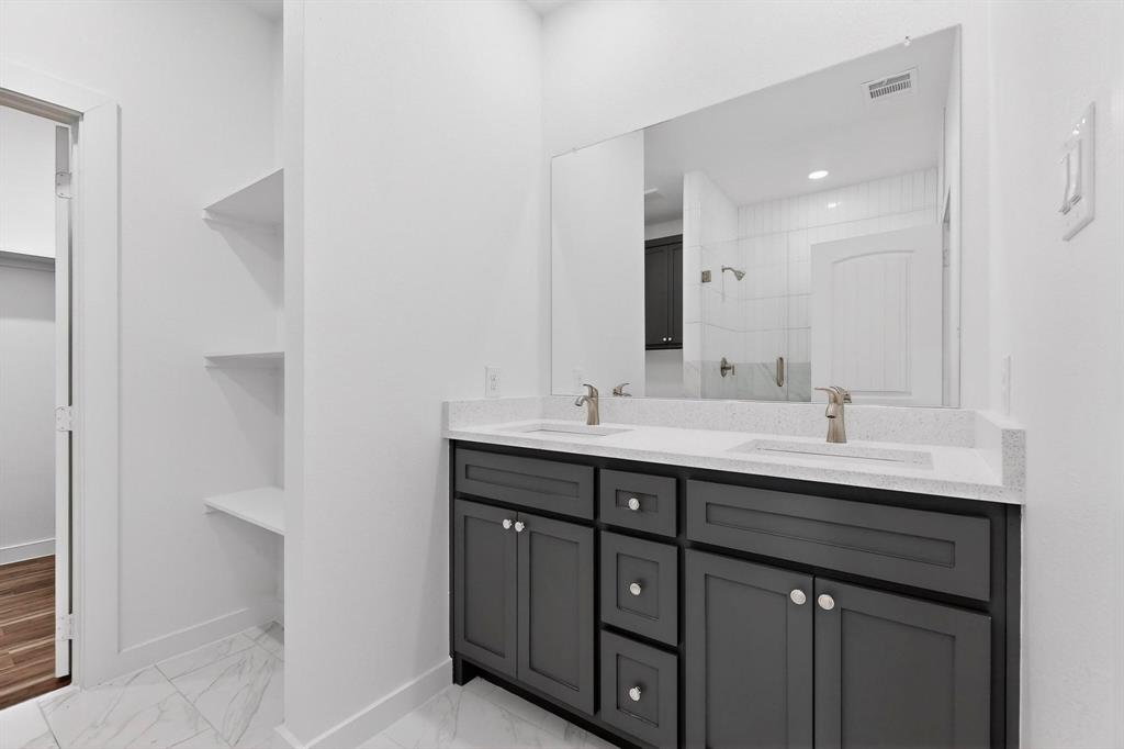 4606 Metropolitan Avenue Dallas, TX 75210 - Photo 12 of 21 a bathroom with a double vanity sink and a mirror