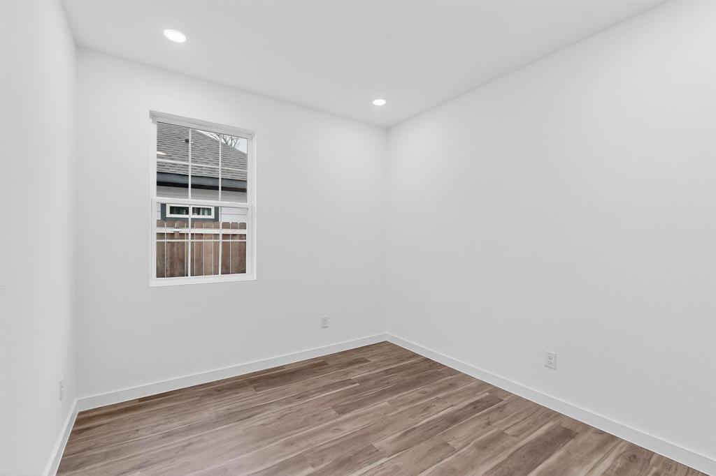 4606 Metropolitan Avenue Dallas, TX 75210 - Photo 16 of 21 an empty room with wooden floor and windows