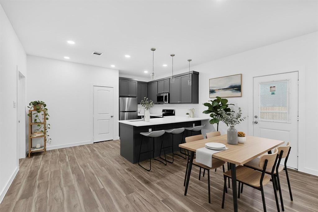 4606 Metropolitan Avenue Dallas, TX 75210 - Photo 5 of 21 a kitchen with a table and chairs in it
