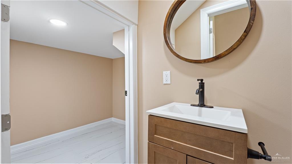 1707 West B Street Mission, TX 78572 - Photo 11 of 12 a bathroom with a sink and a mirror