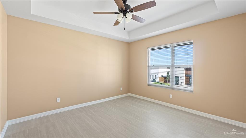 1707 West B Street Mission, TX 78572 - Photo 5 of 12 an empty room with a window and a ceiling fan