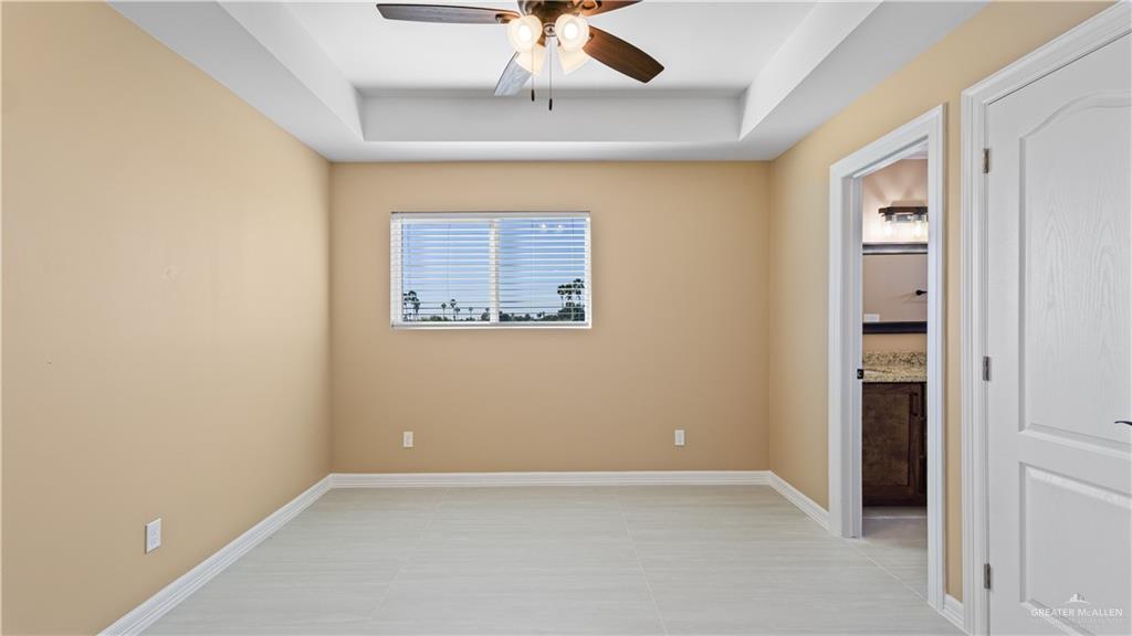 1707 West B Street Mission, TX 78572 - Photo 6 of 12 an empty room with a ceiling fan and carpet