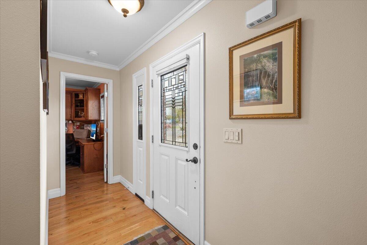440 Bush Street Central Point, OR 97502 - Photo 5 of 40 a view of a hallway with wooden floor and a living room