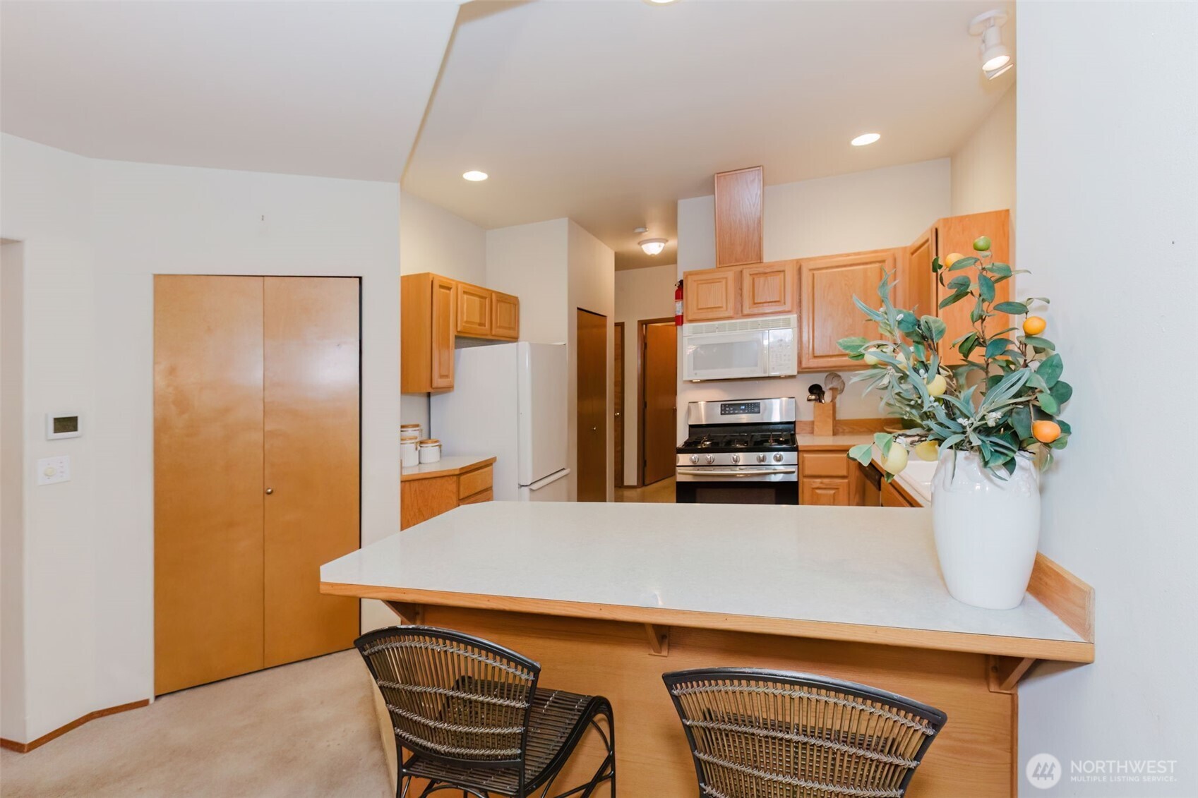 8911 Roanoke Road Northeast Bremerton, WA 98311 - Photo 11 of 40 a kitchen with stainless steel appliances a refrigerator and a sink