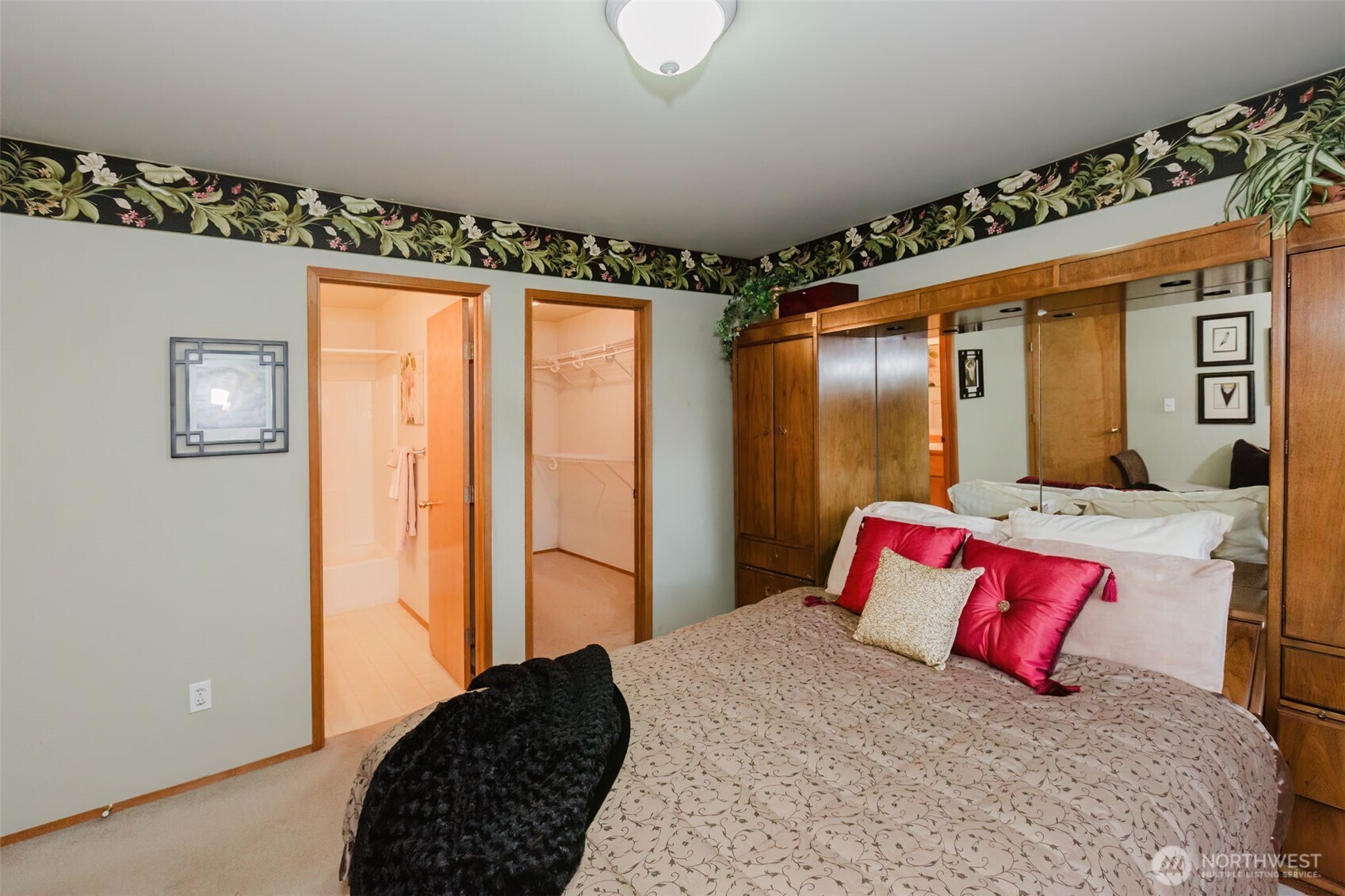 8911 Roanoke Road Northeast Bremerton, WA 98311 - Photo 20 of 40 a bedroom with a large bed and a chandelier