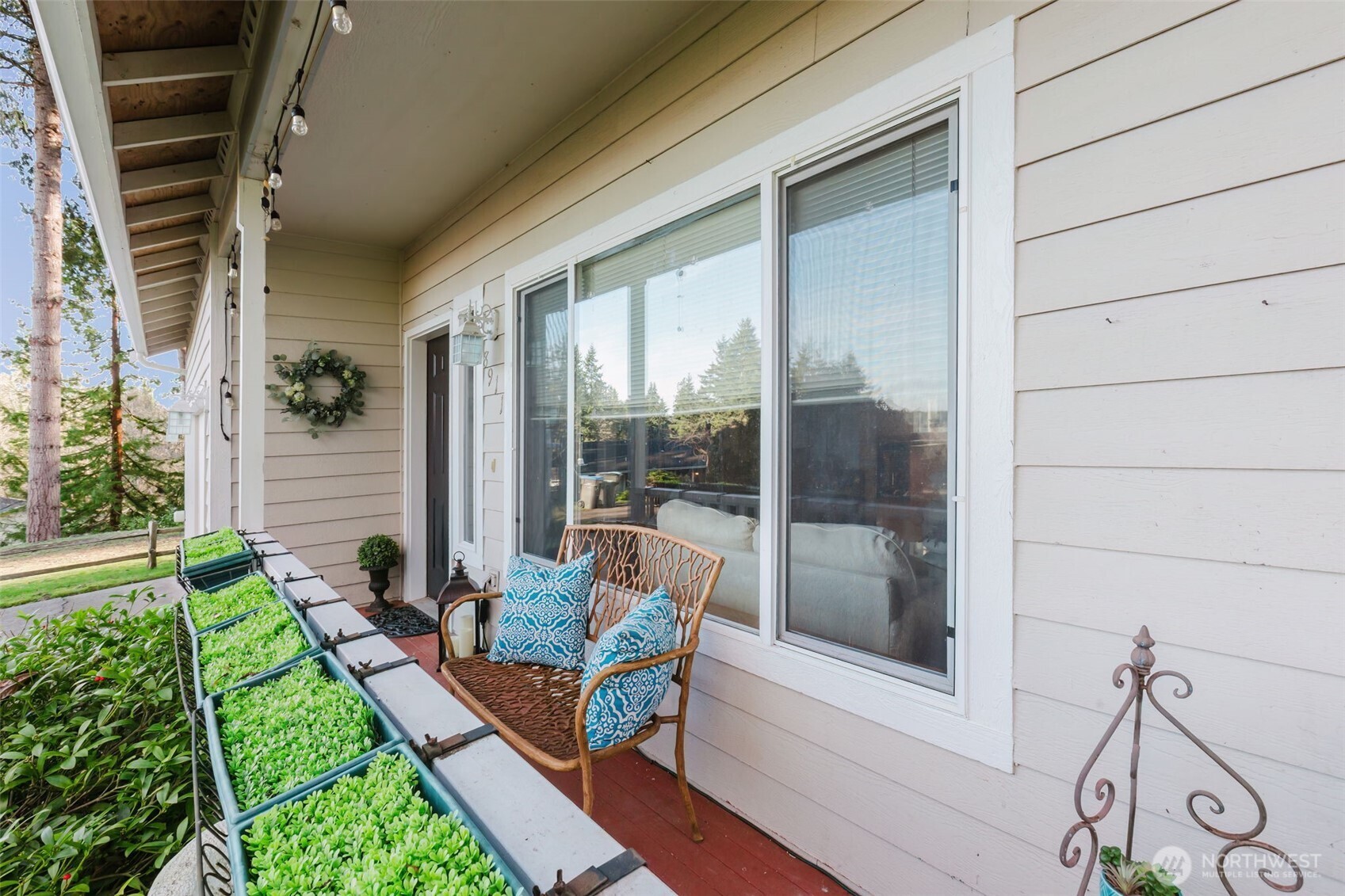 8911 Roanoke Road Northeast Bremerton, WA 98311 - Photo 2 of 40 a backyard of a house with outdoor seating and plants
