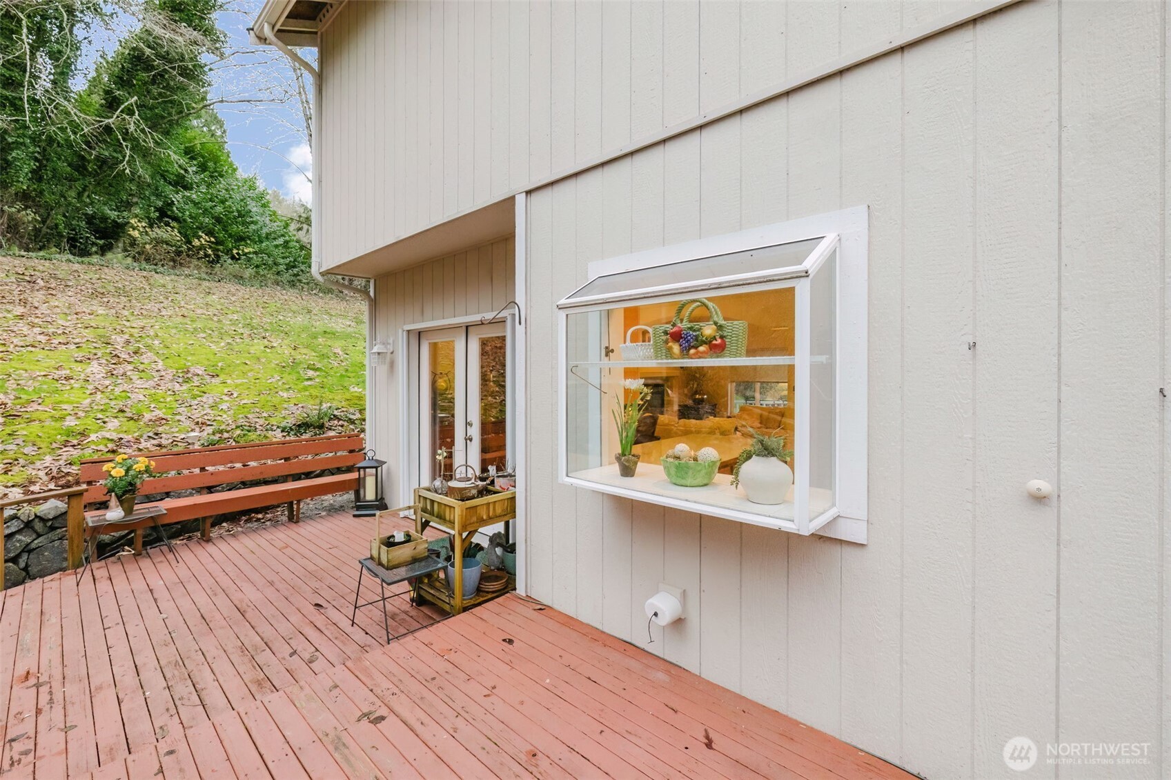 8911 Roanoke Road Northeast Bremerton, WA 98311 - Photo 33 of 40 a view of a house with a patio and wooden floor