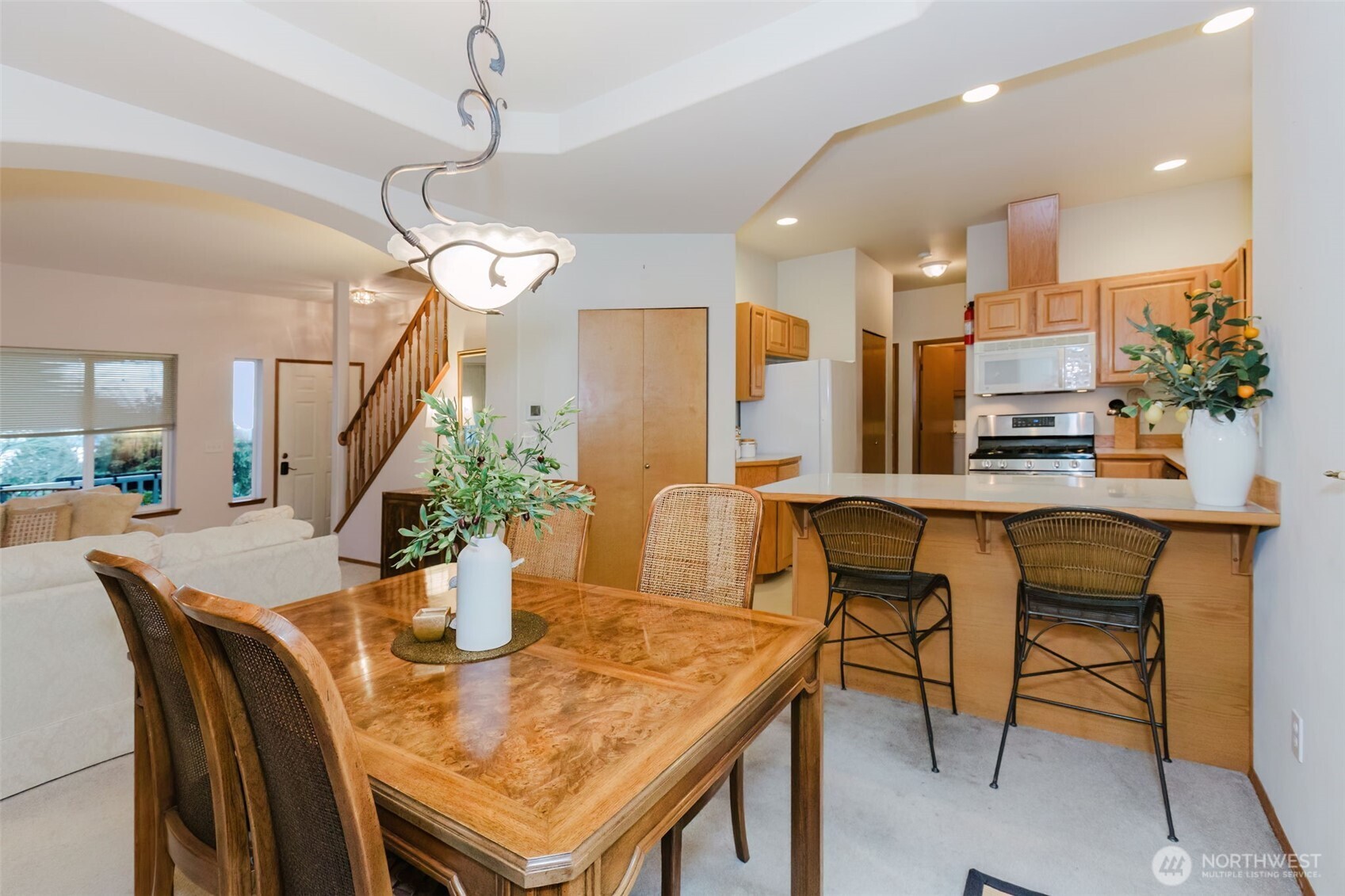 8911 Roanoke Road Northeast Bremerton, WA 98311 - Photo 9 of 40 a view of a dining room with furniture and a chandelier