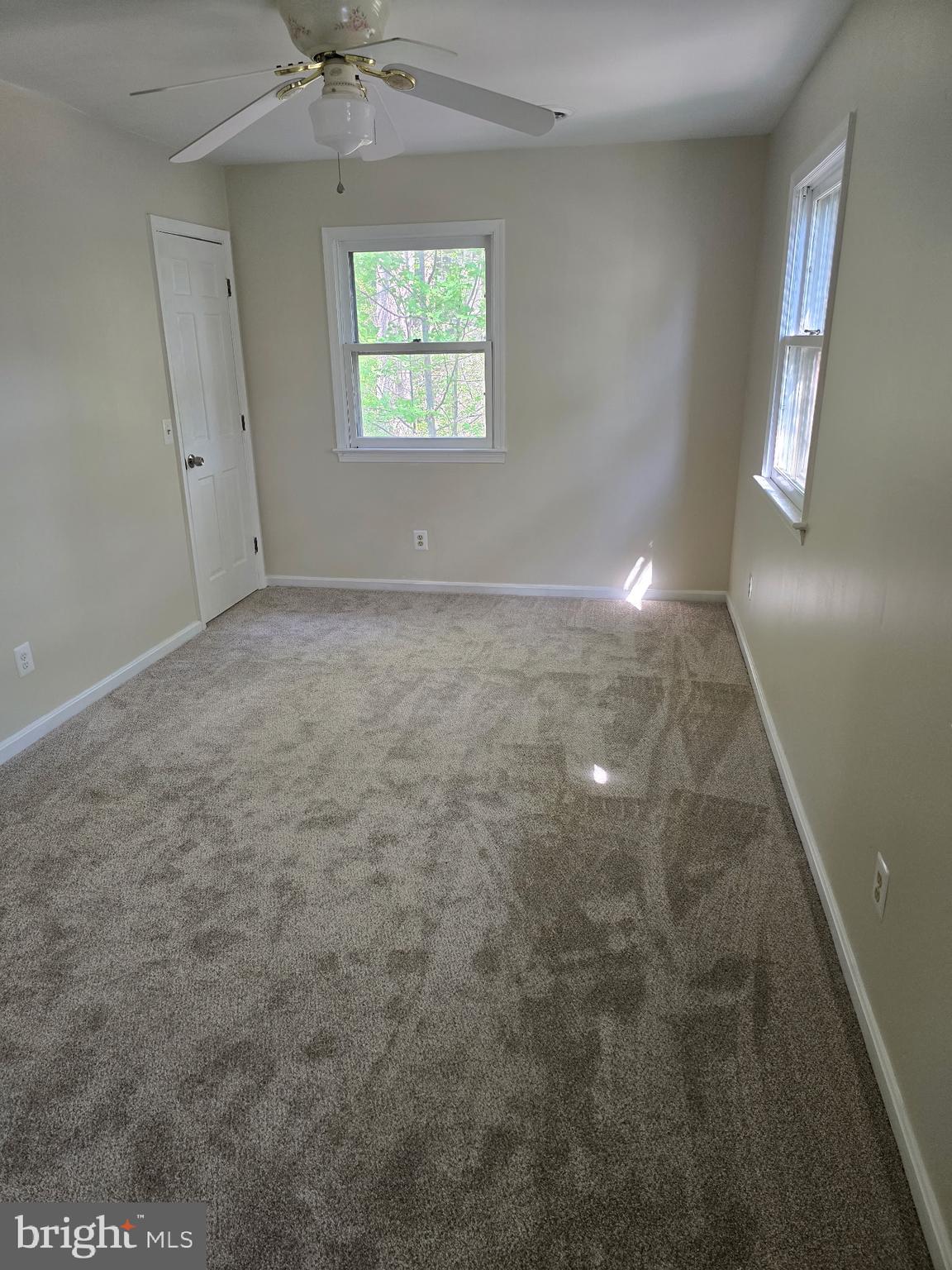 439 Ridgemore Street Fredericksburg, VA 22405 - Photo 14 of 17 en empty room with windows and chandelier fan