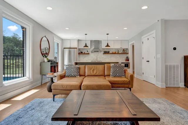 a living room with furniture rug and wooden floor