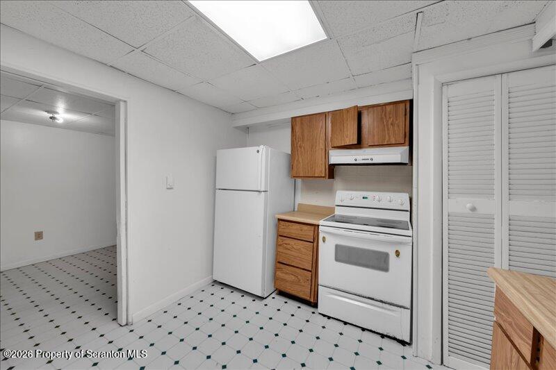 1228 Lake Road Factoryville, PA 18419 - Photo 14 of 43 a kitchen with a refrigerator and a stove