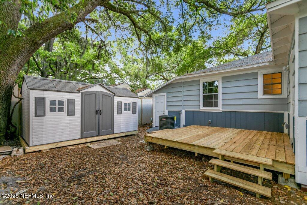 1263 Macarthur Street Jacksonville, FL 32205 - Photo 20 of 37 a view of backyard of house with wooden fence and large trees
