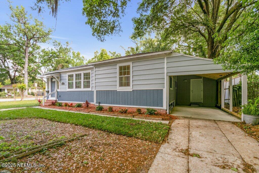 1263 Macarthur Street Jacksonville, FL 32205 - Photo 21 of 37 a front view of a house with a yard and potted plants