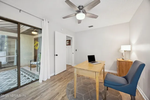 a bedroom with a bed and a desk