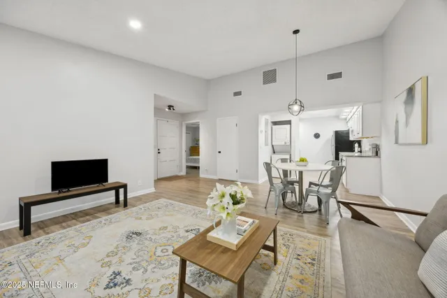 a living room with furniture a dining table and a fireplace