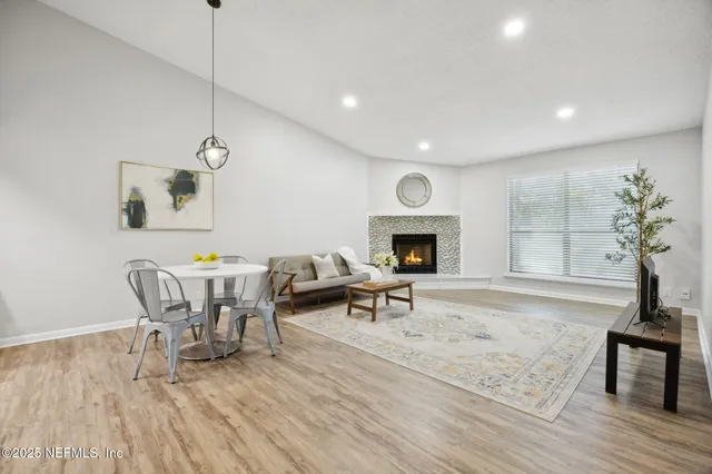 a living room with furniture a window and a fireplace