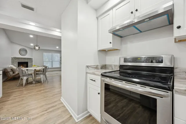 a kitchen with a stove and a fireplace