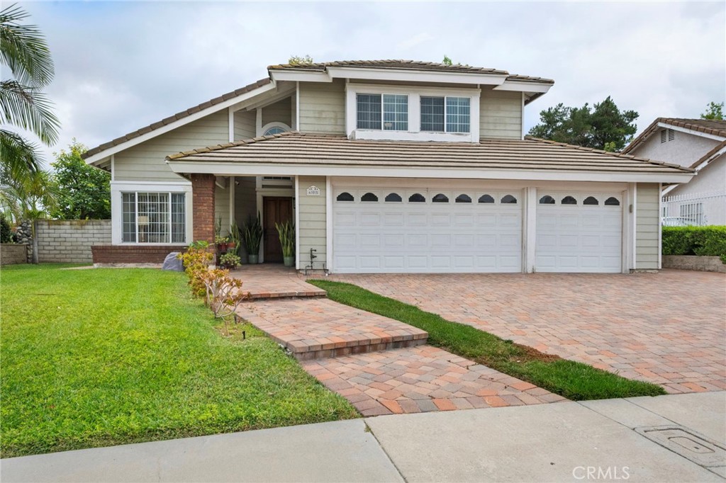 605 Bronco Way Walnut, CA 91789 - Photo 1 of 69 a front view of a house with a yard and potted plants