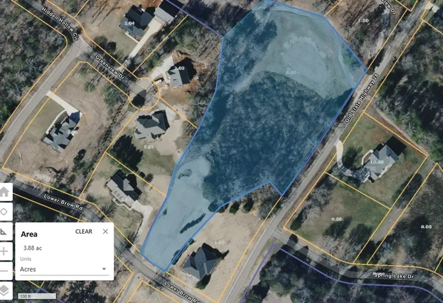 an aerial view of a house with a mountain