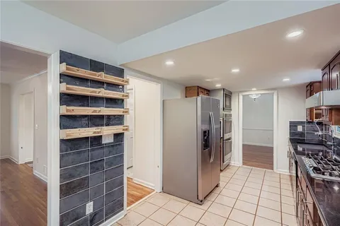 a view of empty room with wooden floor and cabinets