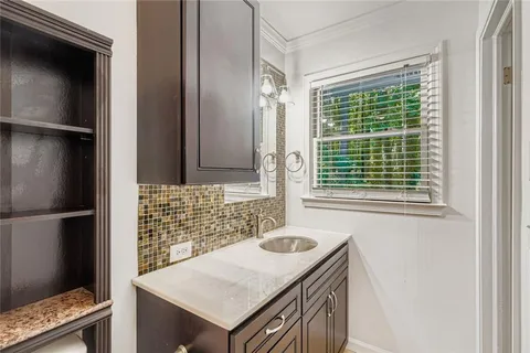 a bathroom with a sink and a window