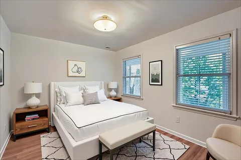 a bedroom with a bed and a lamp next to a window